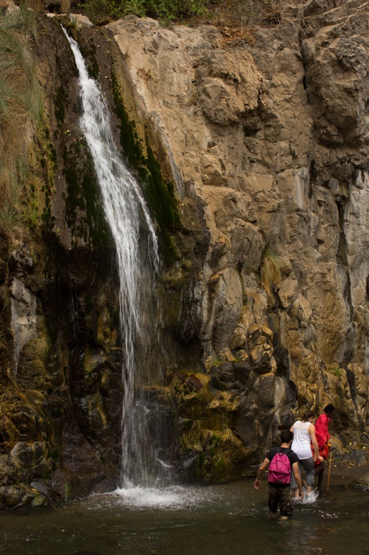 Hike through river enroute to waterfall lake natron