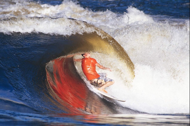 World champion skimboarder Bill Bryan performs a surfing 'layback' tube ride at Rapid 11 a few years 