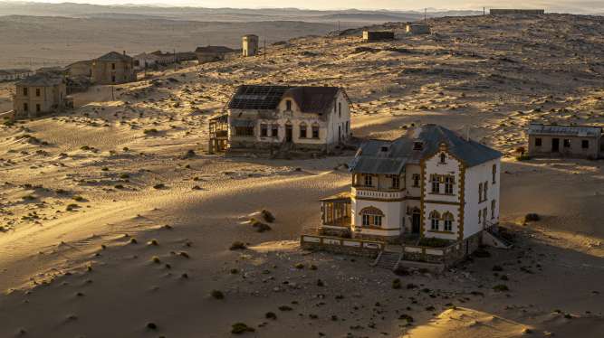 Abandoned houses in Kolmanskop, historic diamond mining town in Namibia