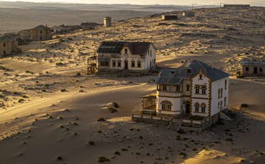 Abandoned houses in Kolmanskop, historic diamond mining town in Namibia