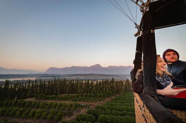 Smiling Safari Guests on Hot Air Balloon Ride in Africa