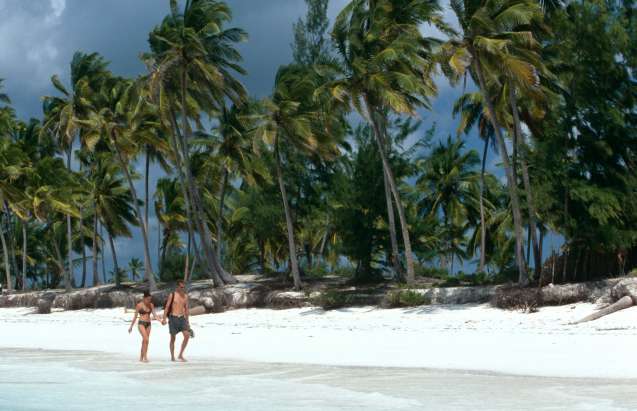Couple walking on Zanzibar beach