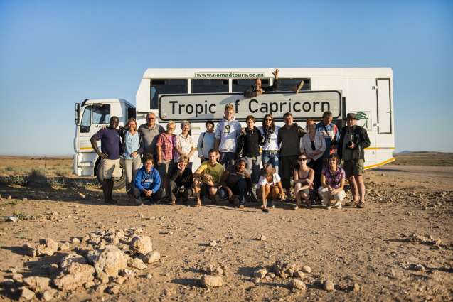 Namibia overland safari group photo on the Tropic of Capricorn