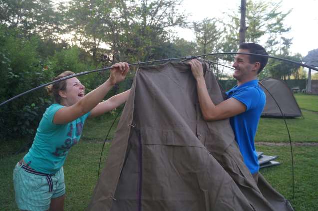 Overland safari group pitching tent together